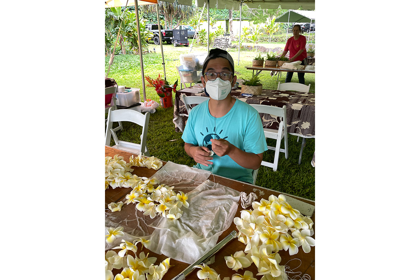 Weon Weian learns lei making in helping to prepare for PAʻI Foundation’s luau for the Smithsonian Institute.